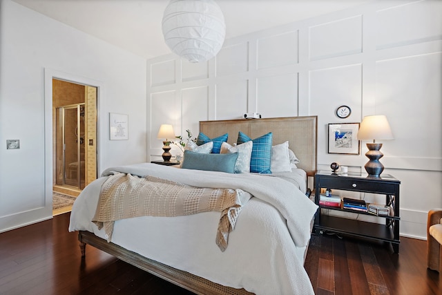 bedroom featuring hardwood / wood-style flooring and connected bathroom