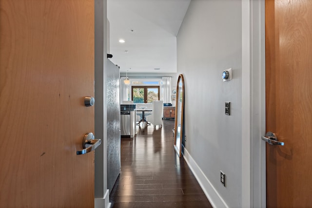 hall featuring vaulted ceiling and dark wood-type flooring