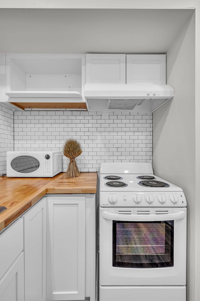 kitchen with wood counters, white appliances, tasteful backsplash, and white cabinetry