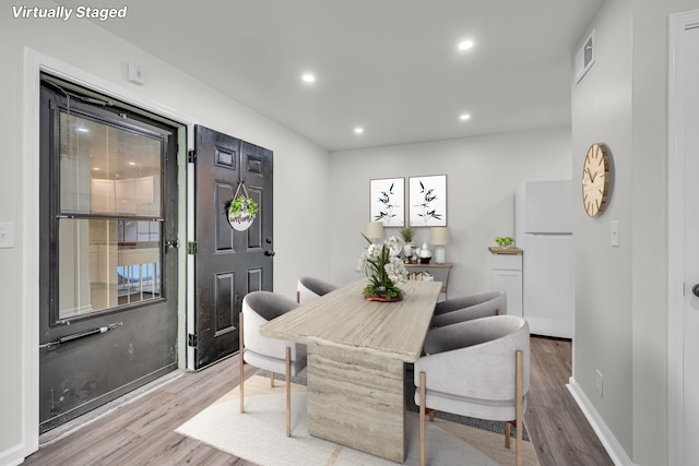 dining area with hardwood / wood-style floors