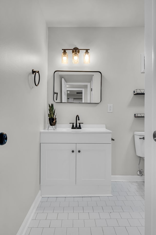 bathroom featuring tile patterned floors, vanity, and toilet