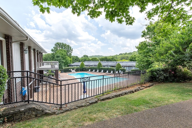 view of pool featuring a patio area and a yard