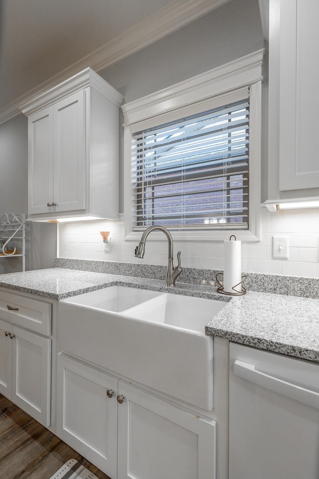 kitchen with backsplash, light stone countertops, dark hardwood / wood-style flooring, and white cabinets