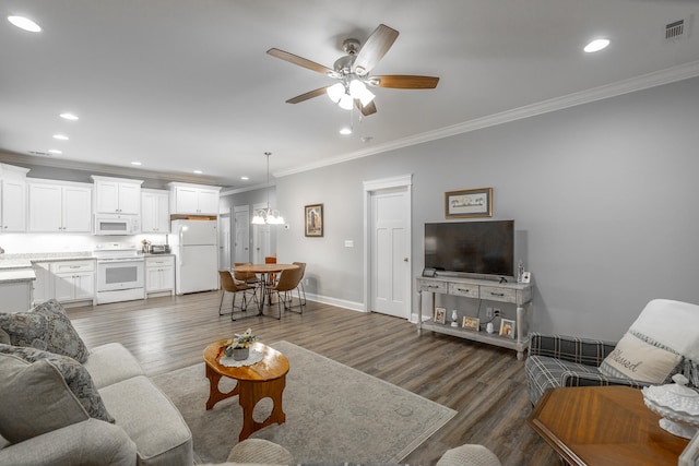 living room with crown molding, ceiling fan, and dark wood-type flooring