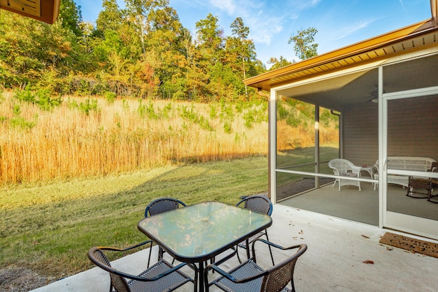 view of patio / terrace featuring a sunroom