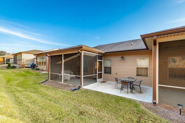 back of property with a sunroom, a yard, and a patio