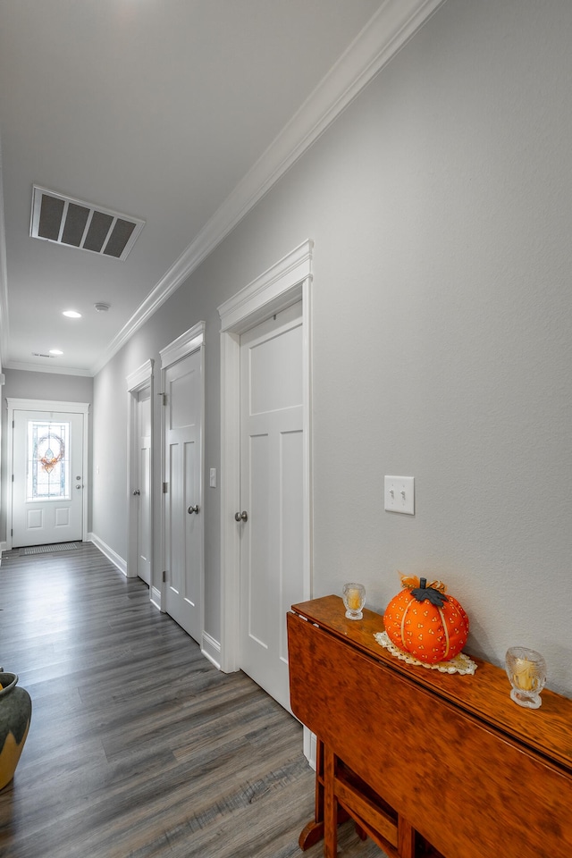 hallway featuring ornamental molding and dark wood-type flooring