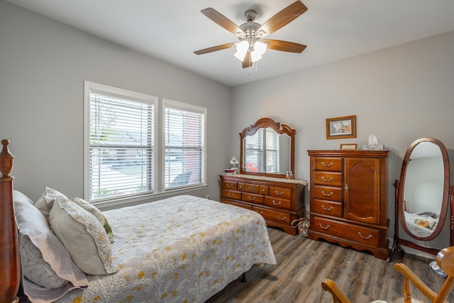 bedroom featuring multiple windows, ceiling fan, and wood-type flooring