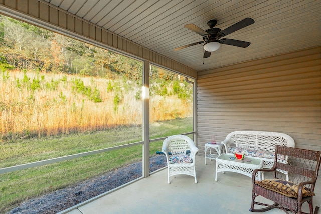 sunroom featuring ceiling fan and wooden ceiling