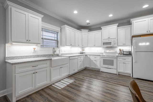 kitchen featuring white cabinetry and white appliances