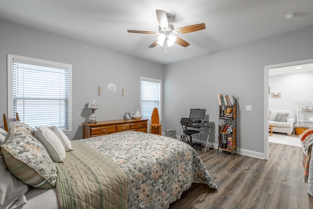 bedroom featuring multiple windows, dark hardwood / wood-style flooring, and ceiling fan