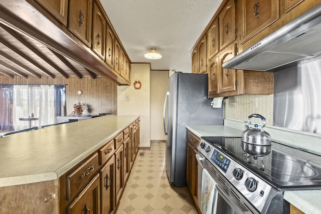 kitchen featuring beamed ceiling, stainless steel electric range, and extractor fan