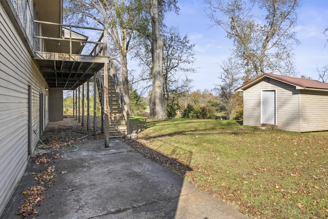 view of yard featuring a patio and a storage shed