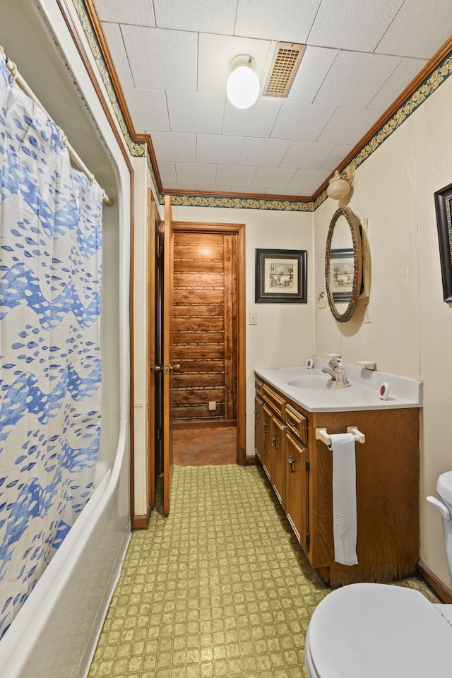 full bathroom featuring vanity, toilet, ornamental molding, and shower / bath combo