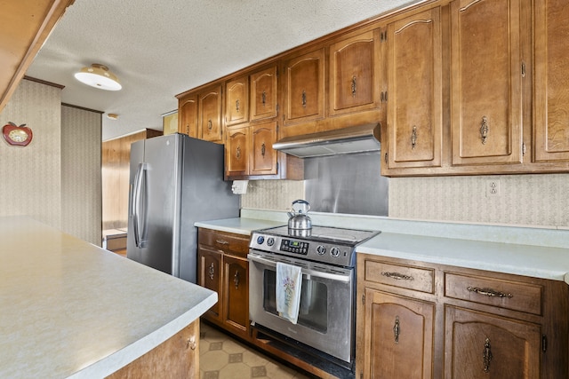 kitchen featuring extractor fan, a textured ceiling, and appliances with stainless steel finishes