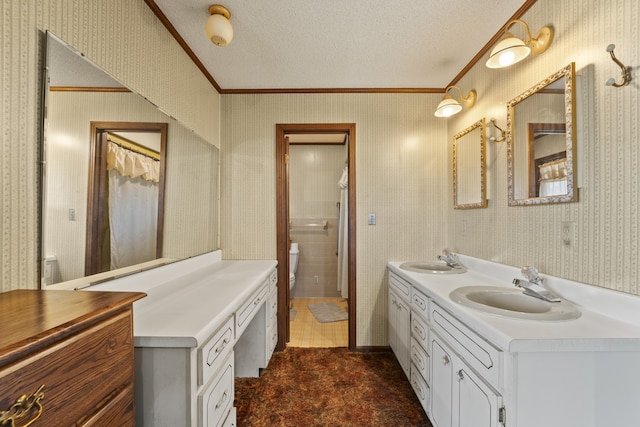 bathroom featuring vanity, a textured ceiling, and ornamental molding