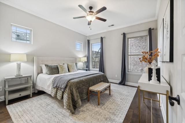 bedroom featuring hardwood / wood-style floors, ornamental molding, and ceiling fan