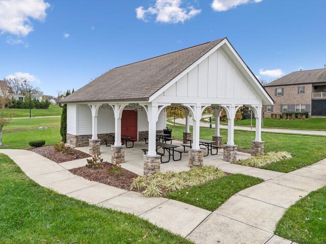 view of community with a gazebo, a patio, and a lawn