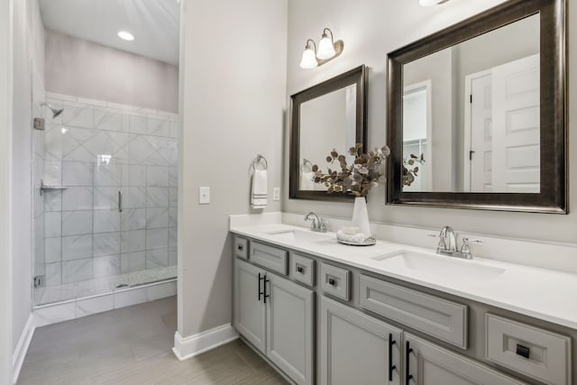 bathroom featuring a shower with door and vanity