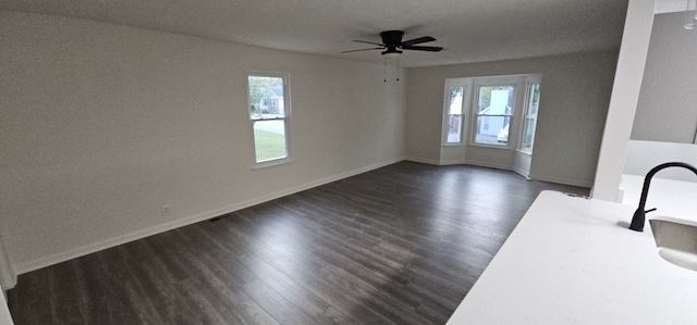 interior space with dark hardwood / wood-style floors, ceiling fan, and a healthy amount of sunlight