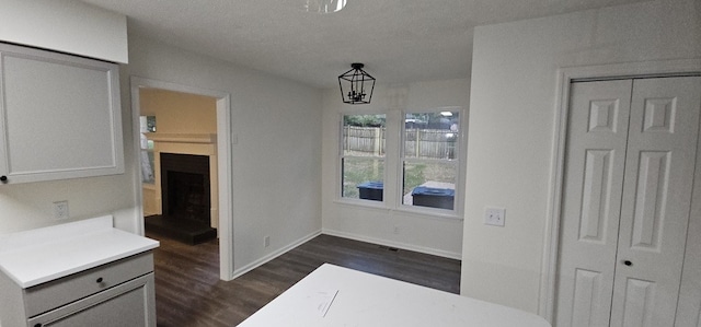 dining room featuring a chandelier, a textured ceiling, and dark hardwood / wood-style flooring