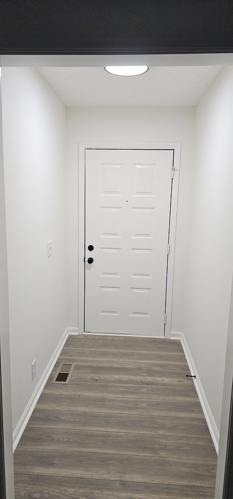 doorway to outside with dark hardwood / wood-style flooring