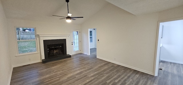 unfurnished living room with a healthy amount of sunlight, ceiling fan, and dark wood-type flooring