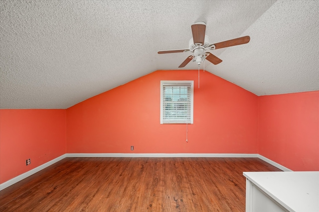 bonus room with hardwood / wood-style floors, ceiling fan, lofted ceiling, and a textured ceiling