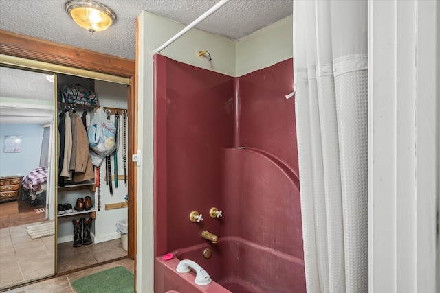 bathroom featuring tile patterned flooring, shower / bathtub combination with curtain, and a textured ceiling