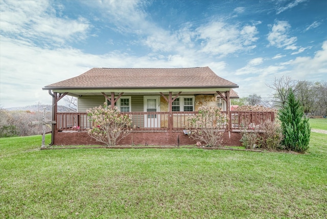 back of house featuring covered porch and a yard