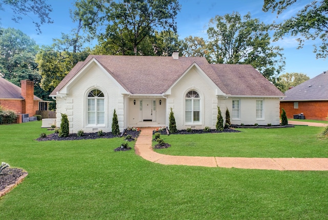 ranch-style home featuring a front yard