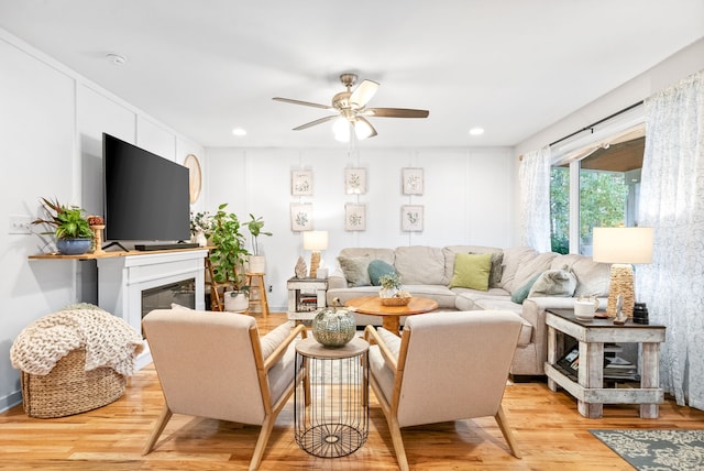 living room with ceiling fan and light hardwood / wood-style floors