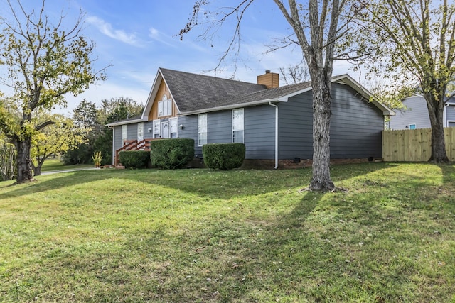 view of side of home featuring a yard