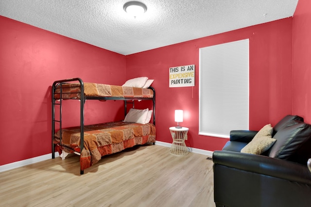 bedroom featuring wood-type flooring and a textured ceiling