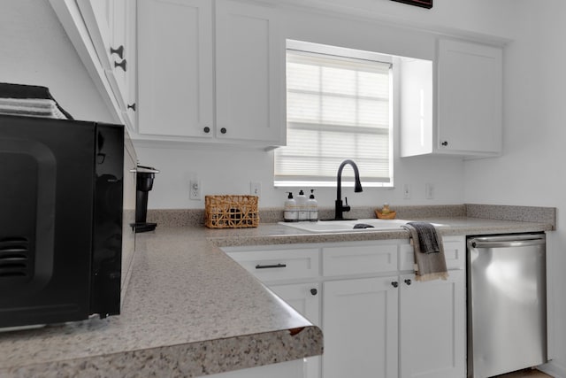 kitchen with white cabinets, dishwasher, and sink