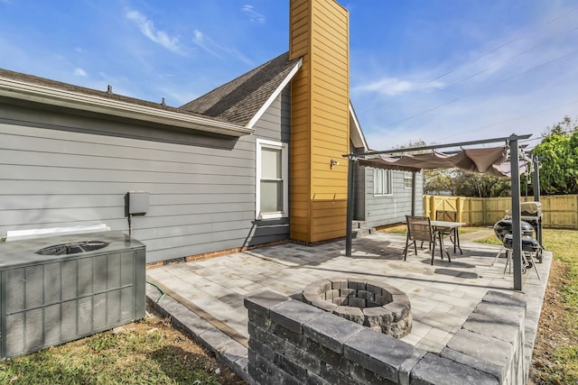 view of patio featuring a pergola, cooling unit, and a fire pit