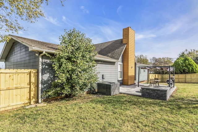 back of property featuring central air condition unit, a patio area, and a yard