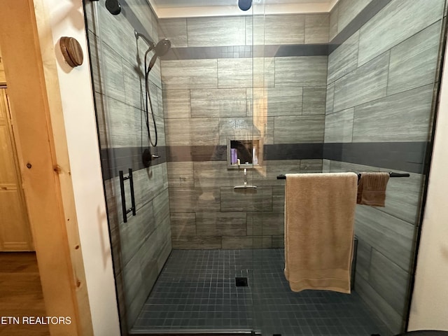 bathroom with tile patterned floors and walk in shower