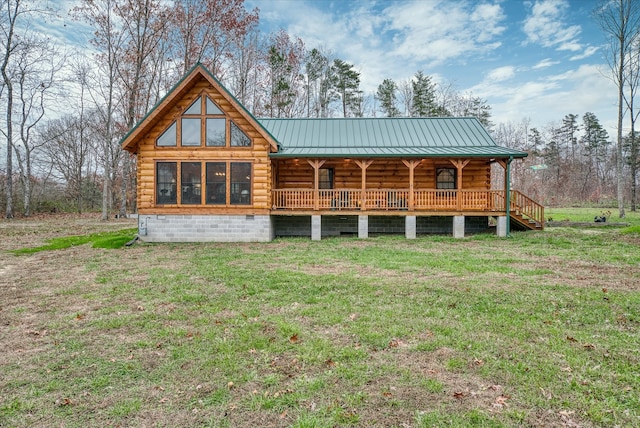 rear view of house with a lawn and a sunroom