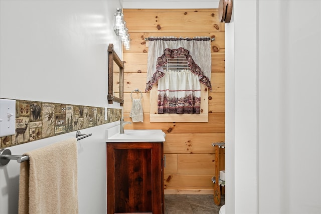 bathroom with tile patterned floors, vanity, and wooden walls