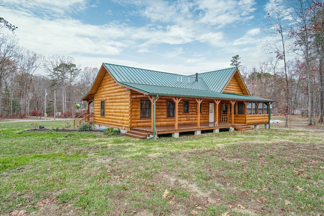 back of property featuring covered porch and a yard