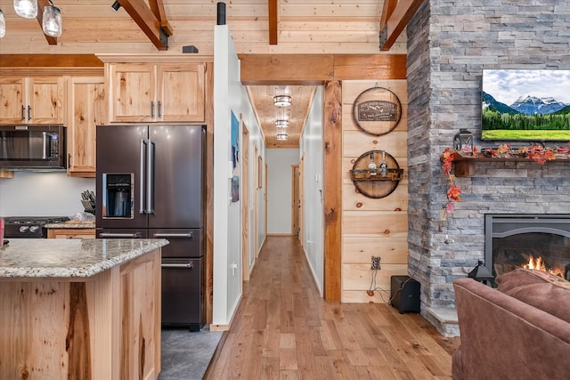 kitchen with light brown cabinets, wooden ceiling, black appliances, beamed ceiling, and light hardwood / wood-style floors