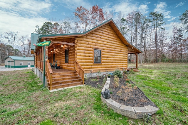 view of home's exterior featuring a yard and an outbuilding