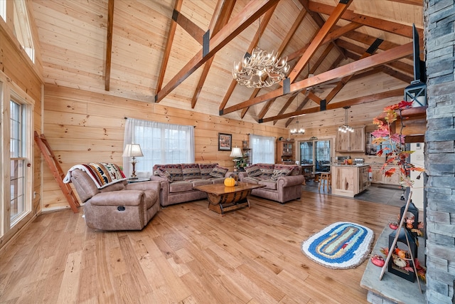 living room featuring light hardwood / wood-style floors, high vaulted ceiling, and a wealth of natural light