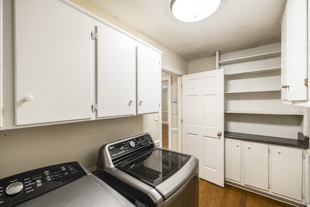 washroom with cabinets, dark hardwood / wood-style flooring, and washing machine and clothes dryer