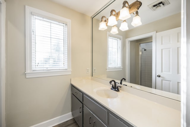 bathroom featuring walk in shower, vanity, wood-type flooring, and an inviting chandelier