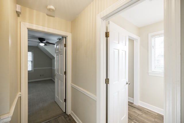 hallway with light hardwood / wood-style floors