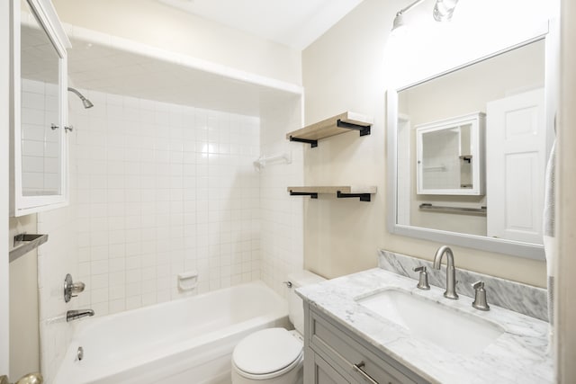 full bathroom with toilet, tiled shower / bath, and vanity