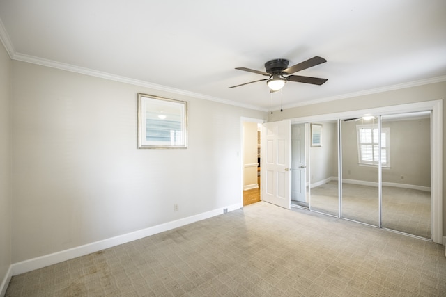 unfurnished bedroom featuring ceiling fan, a closet, and crown molding