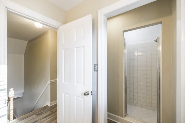 bathroom featuring hardwood / wood-style flooring and an enclosed shower